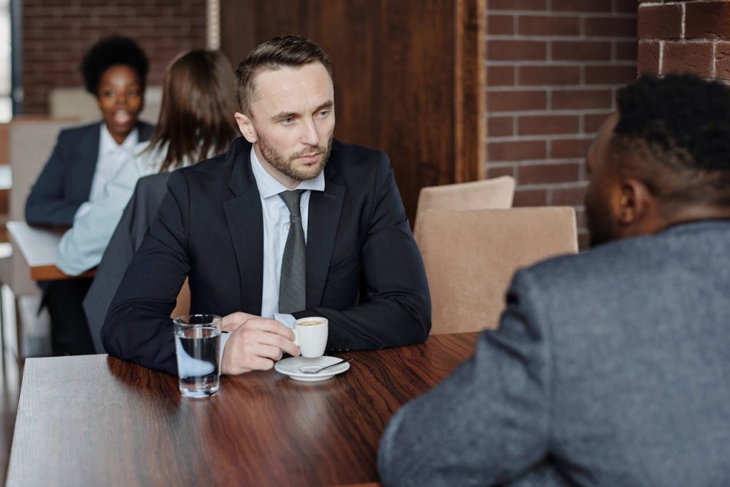 A man opening up during a serious conversation with a friend, illustrating vulnerability and emotional honesty as strengths in healthy masculinity.