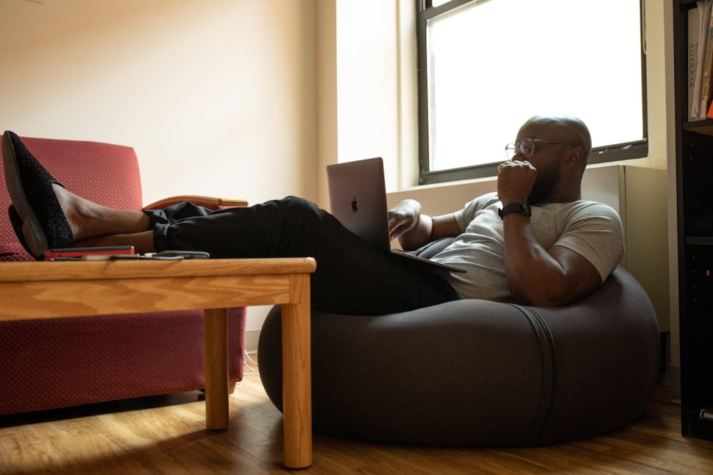 Man researching therapy options on his laptop with a focused, determined expression.