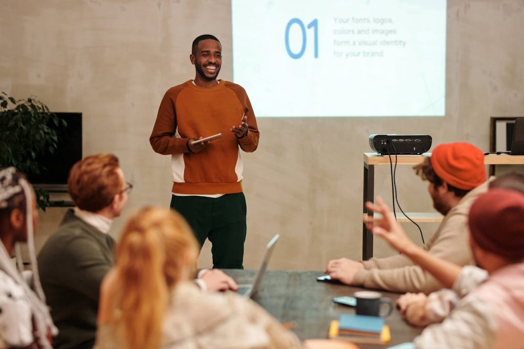 A man confidently leading a meeting while colleagues listen attentively, illustrating emotional intelligence in men through calm leadership and social awareness.