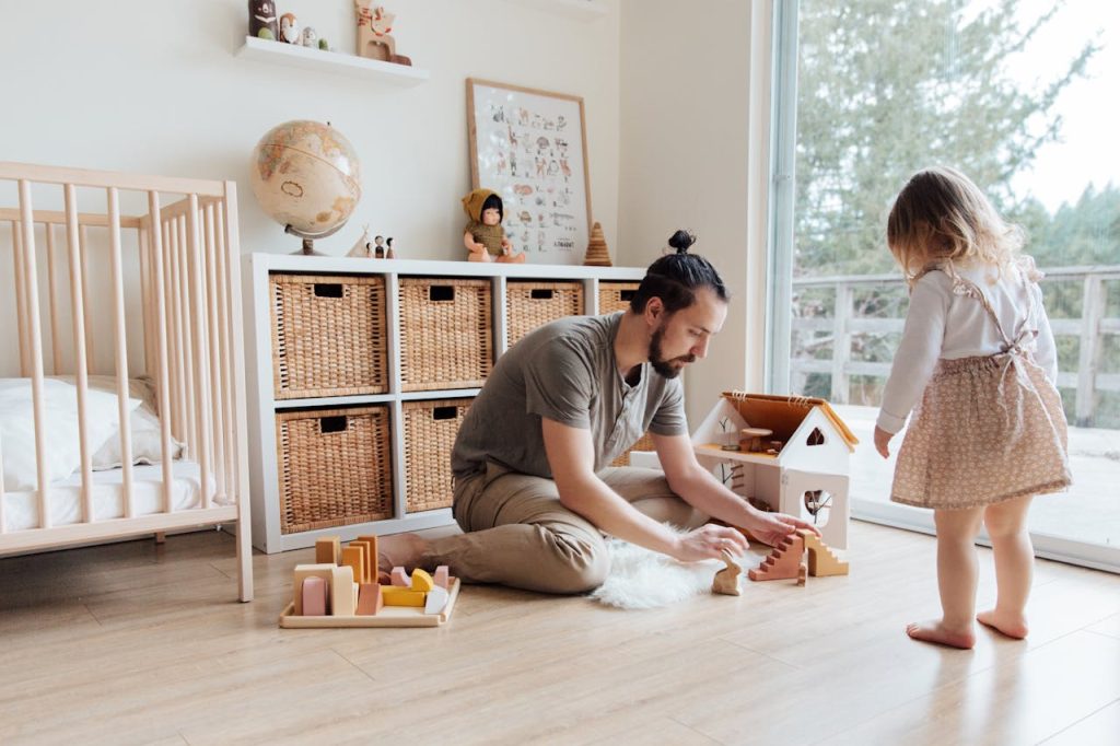 Father playing and learning with his child at home, demonstrating spiritual leadership at home through attentive presence and guidance.