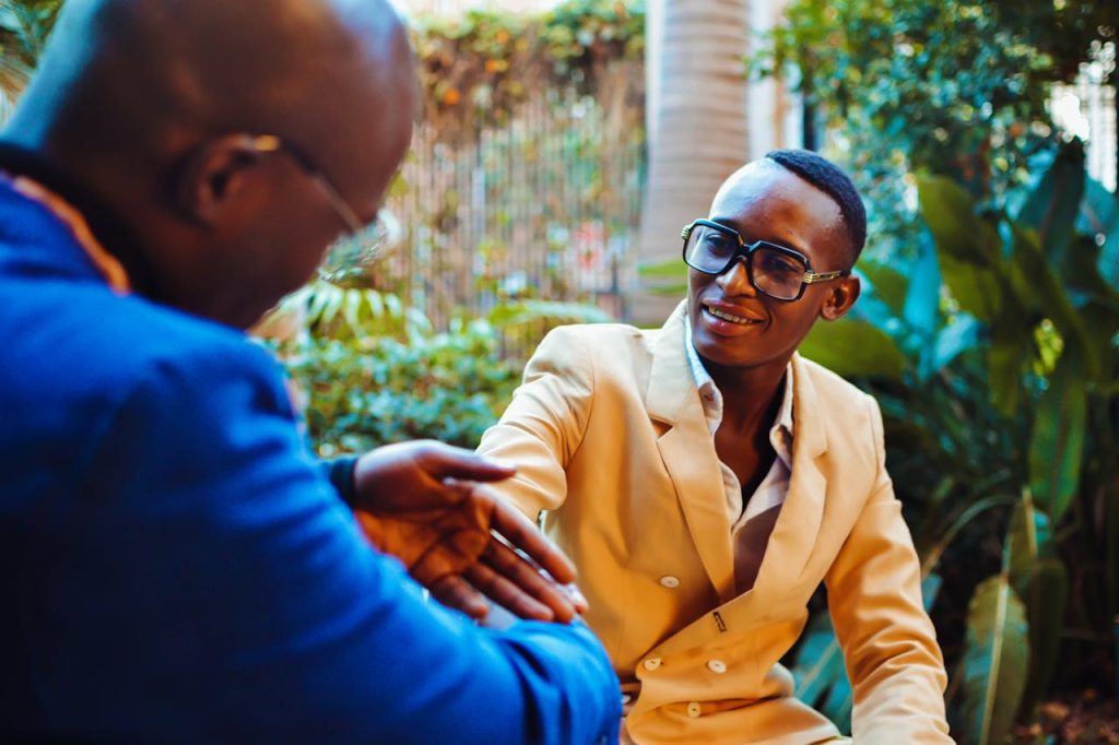 Two men talking openly in an outdoor setting, with one man offering support to the other, symbolizing how vulnerability strengthens male friendships.